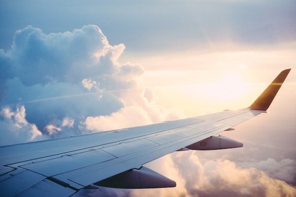 Picture taken from a plane seat shows a vast, beautiful sky and plane's wing